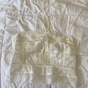 A womens small urban outfitters mesh tank top with flower detailing.